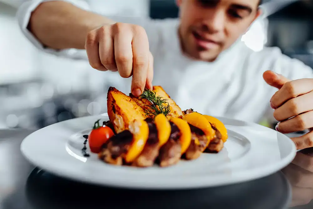 SERVICES-Exceptional Services Chef putting the finishing touches on a delicious-looking plate of food